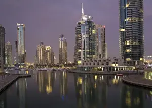 Walk Way Prints: UAE, Dubai, Marina. Tower lights reflect on marina water at night