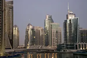 Walk Way Prints: UAE, Dubai. Tower lights reflect on marina water at night