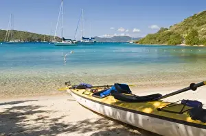 UK, BVI, Norman Island, the Bight. Kayak hauled out on idyllic beach