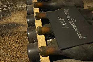 In the underground wine cellar: a pile of bottles of Vosne Romanee Romanee 1971 red