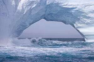 Images Dated 1st November 2007: United Kingdom Territory, South Georgia Island. Waves splash under iceberg arch. Credit as