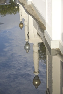 Images Dated 2nd April 2008: United States, Puerto Rico, Ponce. Reflection of lamp posts in puddle, Plaza Las Delicias