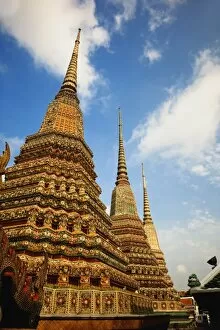 Upward view of trio of chedi, Wat Pho, Bangkok, Thailand