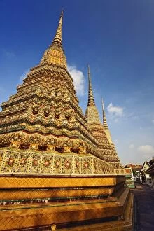 Upward view of trio of chedi at Wat Pho, the oldest temple in Bangkok, Thailand