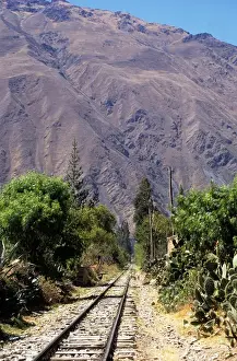 Transporting Prints: Urubamba Valley, Peru. Machu Pichu Railway - railway lines / trucks; mountains; cacti