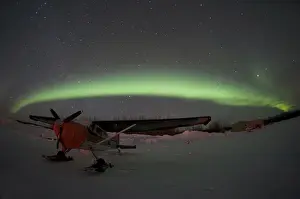Aurora Prints: USA, Alasaka, Bettles. An airplane waits out the night beneath the northern lights