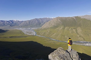 Images Dated 8th July 2010: USA, Alaska, Arctic National Wildlife Refuge. Hiker pausing to admire hill scenery