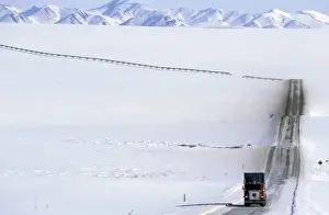Prudhoe Bay Prints: USA, Alaska, Brooks Range. Truck drives on the ice covered haul road to Prudhoe Bay