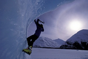 Climb Prints: USA, Alaska, Chugach National Forest. Kristian Sieling climbs iceberg on Portage Lake