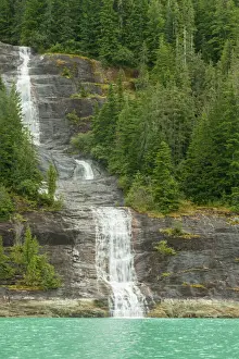 USA, Alaska, Endicott Arm. Mountain waterfall into ocean
