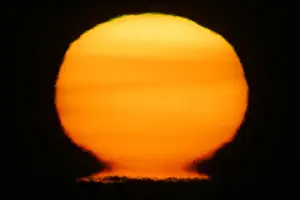 Art Morris Prints: USA, Alaska, Homer. Sun at sunset distorts to look like a nuclear fireball. Credit as