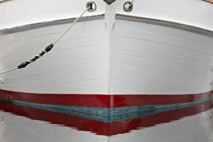Rope Prints: USA, Alaska, Hoonah. Bow of a boat reflects in water