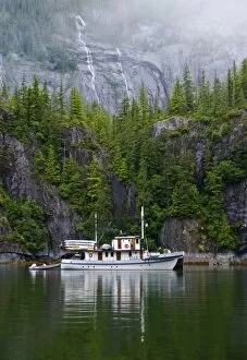 USA, Alaska, Inside Passage. Old boat anchored along shore