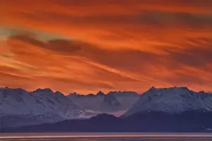 Images Dated 7th March 2009: USA, Alaska, Kachemak Bay. Intense sunrise brightens the sky mountains