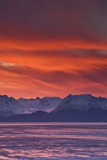 Intense Prints: USA, Alaska, Kachemak Bay. Intense sunrise brightens the sky mountains