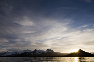 Images Dated 7th July 2008: USA, Alaska, Katmai National Park, Setting sun lights clouds above mountain peaks