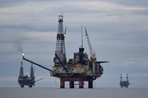 Cloudy Prints: USA, Alaska, Kenai Peninsula, Offshore oil drilling rigs in Cook Inlet on summer evening