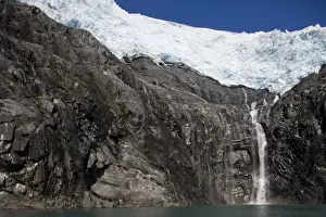 No Clouds Prints: USA, Alaska, Morning sun lights waterfall flowing from Blackstone Glacier in Prince