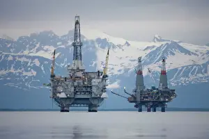Smoke Prints: USA, Alaska, Offshore oil drilling rigs in Cook Inlet and distant Alaska Range peaks