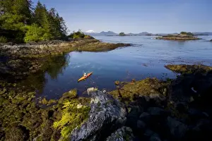 Sea Kayak Prints: USA, Alaska, Sitka Sound. Woman sea kayaker on calm sea near Kruzof Island, Mt. Edgecumbe