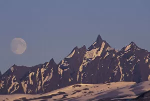 Images Dated 31st August 2003: USA, Alaska, Valdez Moon rises above rugged Chugach Range mountains near Valdez