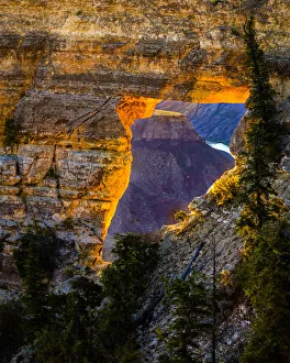 USA, Arizona, Grand Canyon National Park. View through hole in canyon wall at sunrise