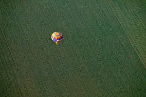Farm Land Prints: USA, Arizona, Val Vista. A brightly colored hot-air balloon soars above farmland