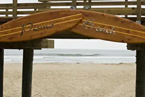 Pismo Beach Prints: USA, CA, Pismo Beach. Vintage wooden surfboards frame entrance to inviting beach