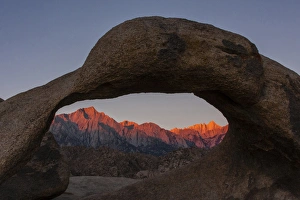 USA, California, Alabama Hills. Mt. Whitney seen through Mobius Arch at sunrise. Credit as