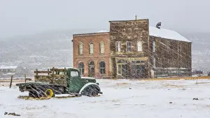 Snowing Prints: USA, California, Bodie. Abandoned buildings in snowfall