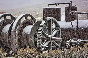Snowing Prints: USA, California, Bodie. Old mining machinery in field