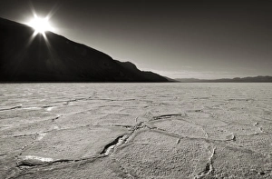 Salt Pan Prints: USA, California, Death Valley. Sunburst over salt pan of Badwater Basin. Credit as