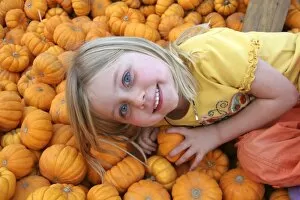 USA, California, Encinitas. A young girl enjoys a local pumpkin patch carnival