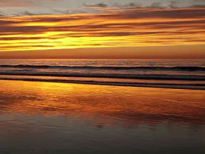 USA, California, La Jolla, Sunset reflected on beach at La Jolla Shores