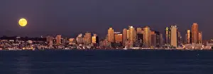 USA, California, San Diego, Panoramic view of full moon rising over city with sunset