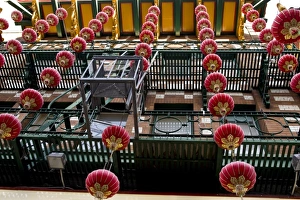China Town Prints: USA, California, San Francisco. Strings of red Chinese lanterns hanging from a balcony