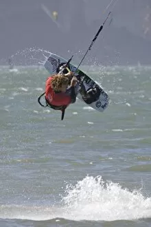USA, California, San Francisco. Jon Modica spins in the air while kiteboarding at
