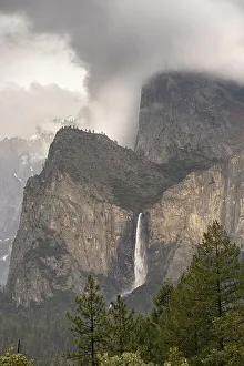 Images Dated 10th April 2022: USA, California, Yosemite National Park. Clouds and mountain with Bridalveil Fall