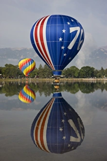 Images Dated 6th September 2009: USA, Colorado, Colorado Springs. Hot air balloons reflected in Prospect Lake