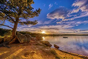 Images Dated 25th October 2022: USA, Colorado, Dowdy Lake. Sunset on lake and people fishing in boat