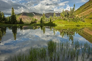 Images Dated 27th July 2015: USA, Colorado, Gunnison National Forest. Paradise Divide and pond reflection. Credit as