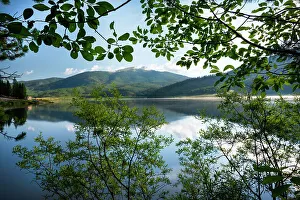 USA, Colorado. Pearl Lake and mountains framed through tree branches
