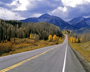 USA, Colorado, San Juan Mountains. A Colorado mountain highway in autumn beckons the driver farther