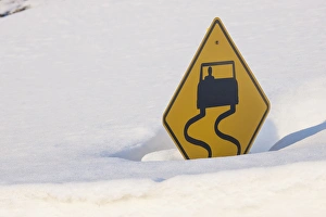 Warning Prints: USA, Colorado. A slippery when wet sign buried in snow