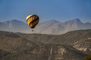 Images Dated 13th November 2020: USA, Colorado, Uncompahgre National Forest. Hot air balloon floats above mountain terrain