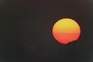 Globe Prints: USA, Florida, Blue Cypress Lake. Sunrise orange and yellow globe with clouds. Credit as