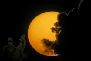 Weather Prints: USA, Florida, Fort De Soto Park. Dark clouds partially cover sun at sunset. Credit as