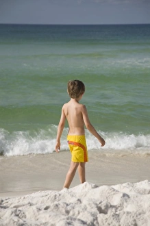 Youth Prints: USA; Florida; Pensacola; Child walking on the beach. (MR)