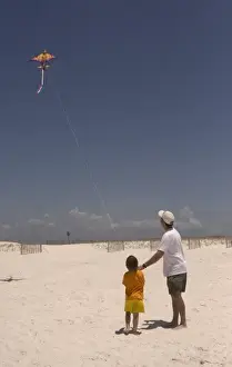 Pensacola Prints: USA; Florida; Young boy learning to fly a kite on the beach at Pensacola. (MR)