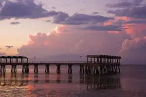 Tidal Prints: USA; Georgia; Jekyll Island. Pier at sunset with approaching storm